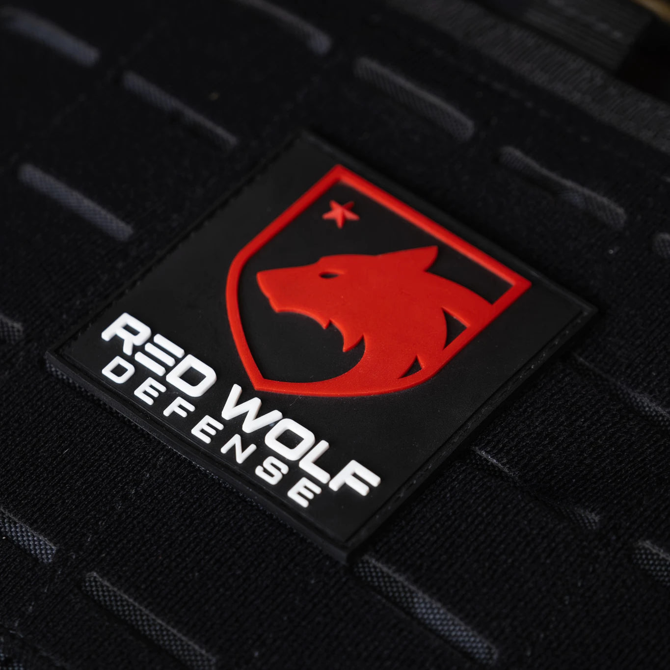 Red Wolf Defense logo patch on tactical gear